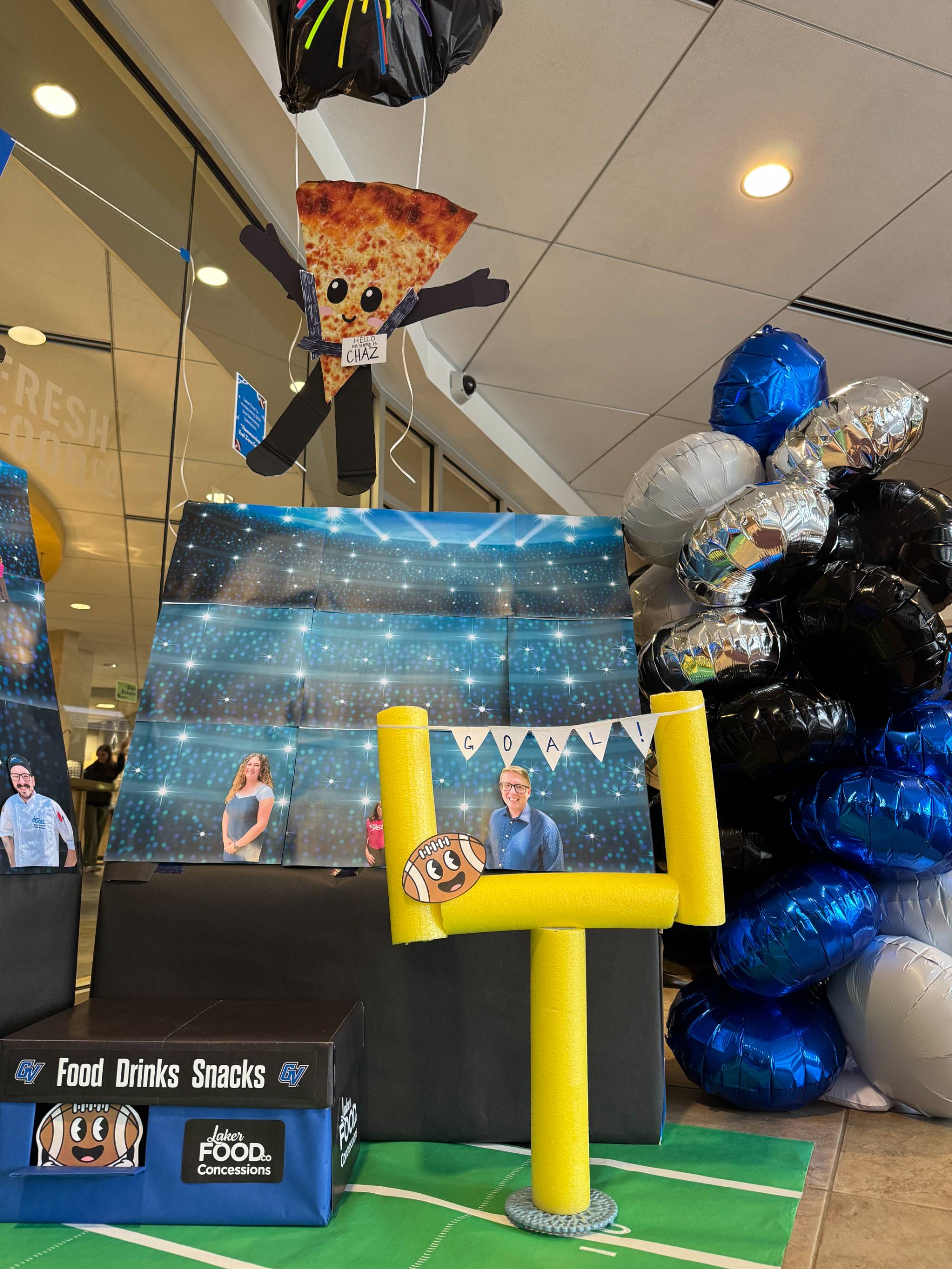 Laker Food Co entrance decorations, goal post and flying pizza named "Chaz"